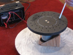 This picture shows the demonstration set-up, consisting of a motor, power supply, and spinning disk full of holes. 